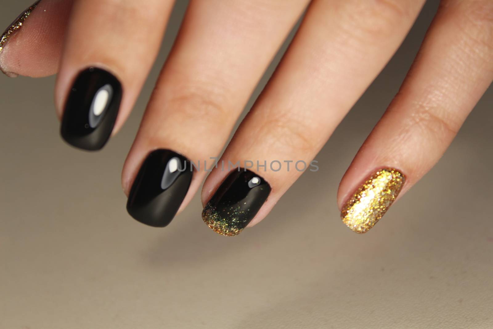 Evening manicure design in black and gold