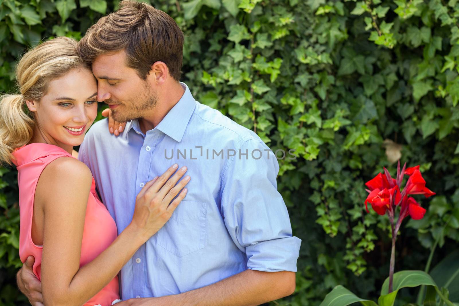 Couple hugging in front yard by Wavebreakmedia