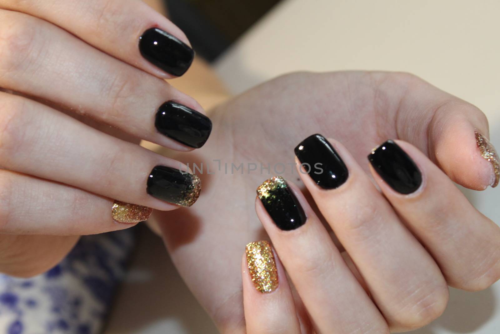 Evening manicure design in black and gold