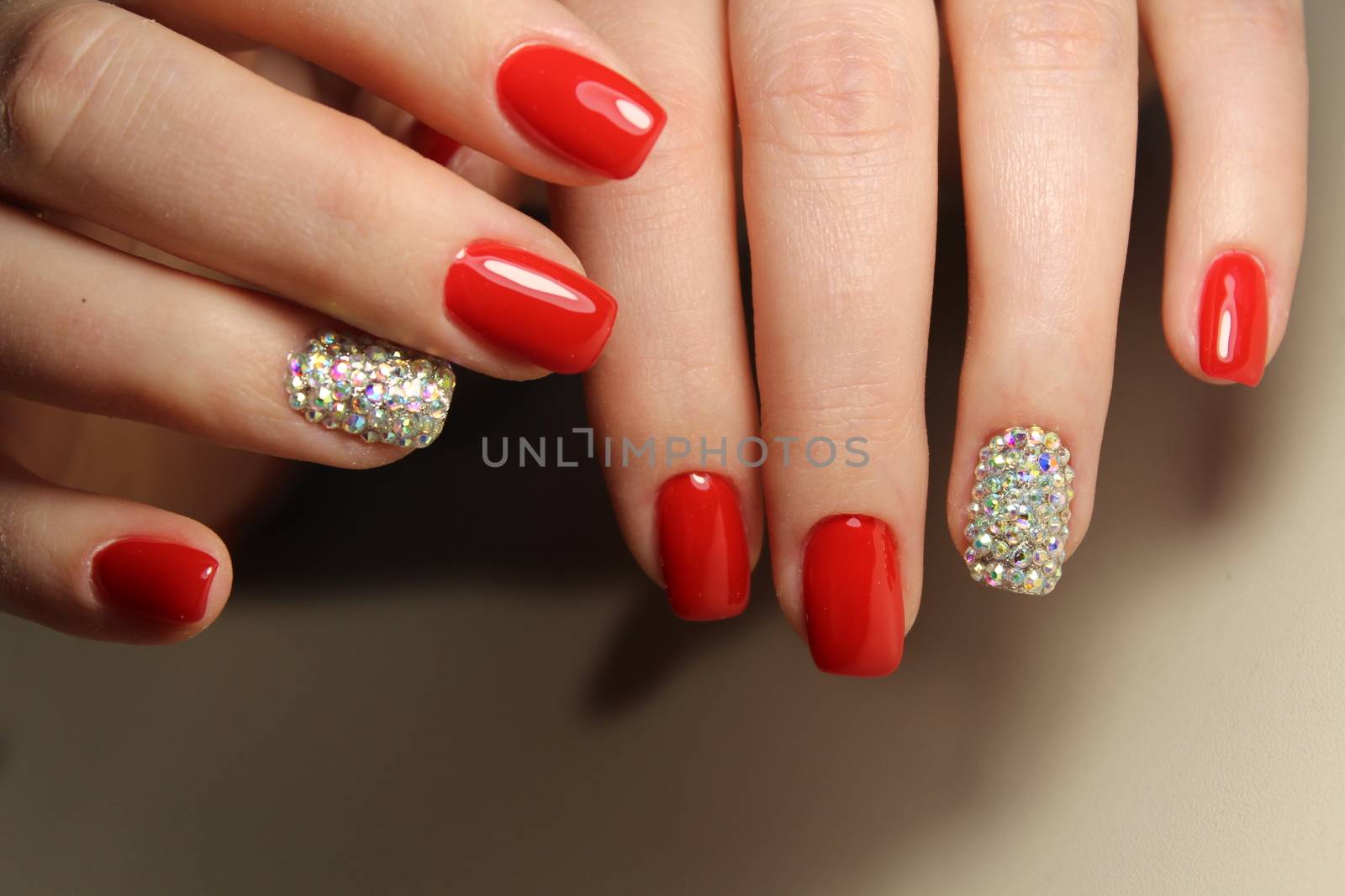 Manicure design gel varnish red nails with rhinestones