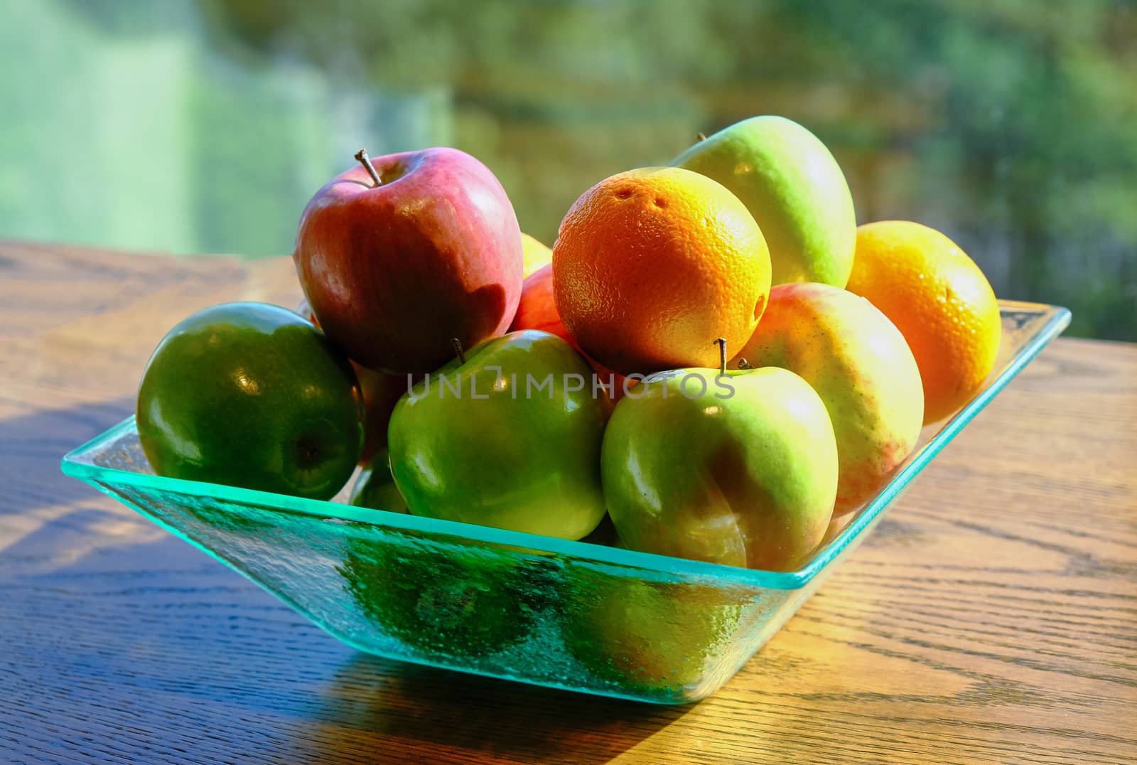 Apples and Oranges in Window LIght in Green Glass Bowl