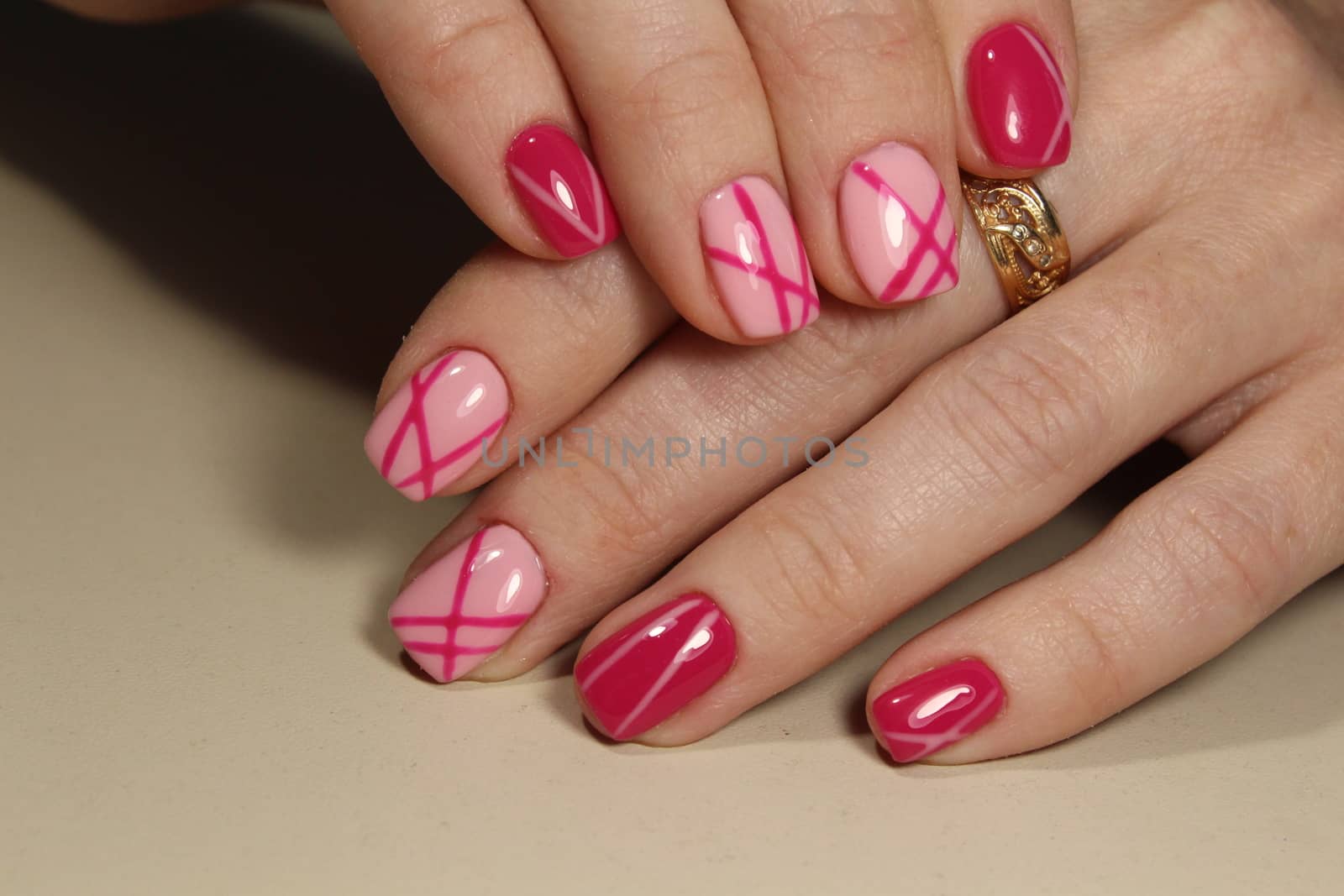 Design manicure nails with pink nail polish.