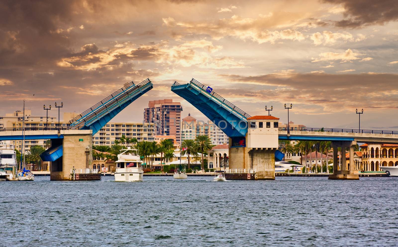 A drawbridge open with boats passing beneath