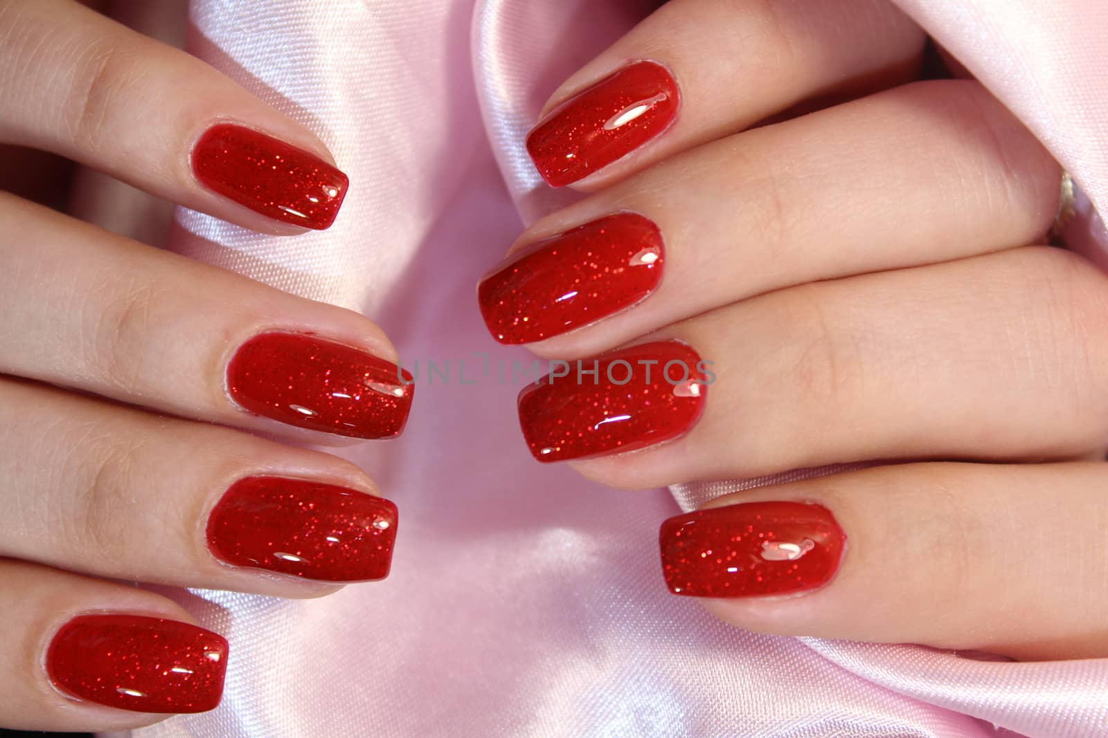 Hands of a woman with red manicure by SmirMaxStock