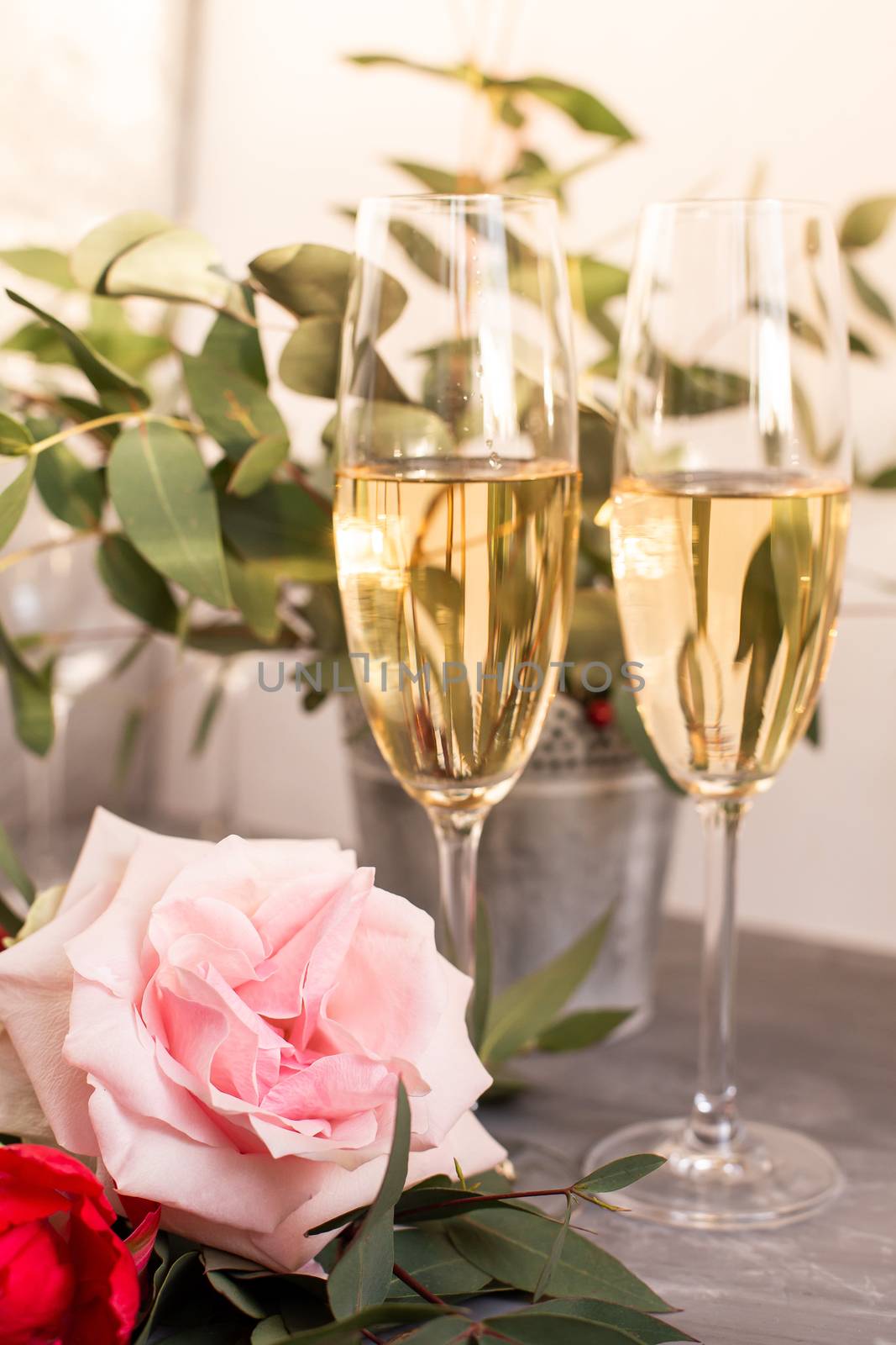 Composition with glasses of vine and flowers on grey concrete background