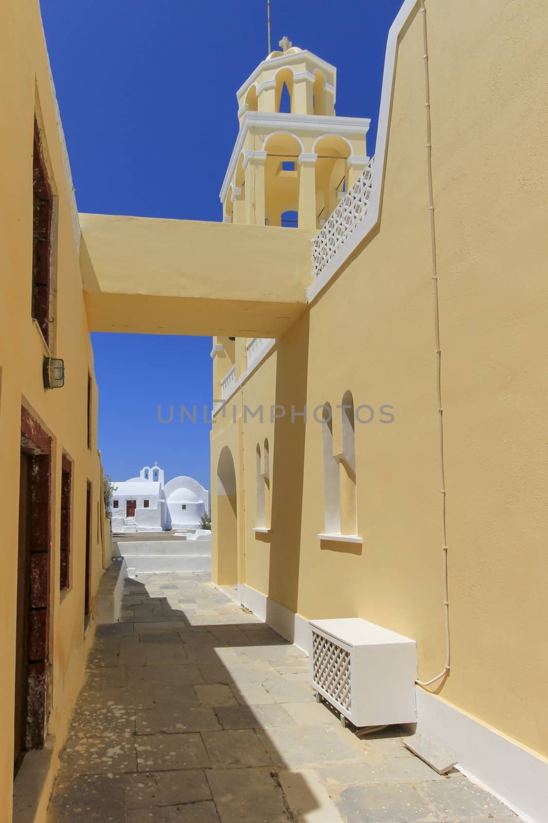 Street next to a church in Oia,Santorini by beautiful day, Greece