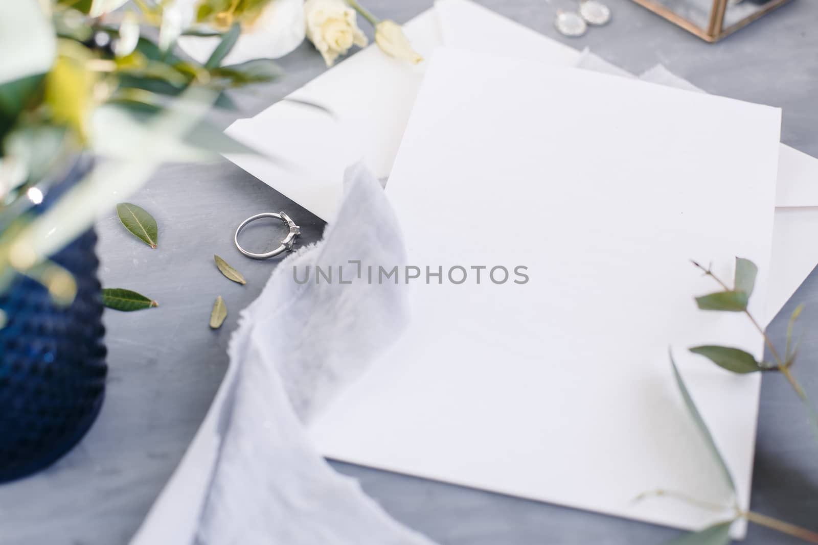 Blank paper copy space. Frame with flowers. Silk ribbon. Gray background. Simple bouquet. Greeting card