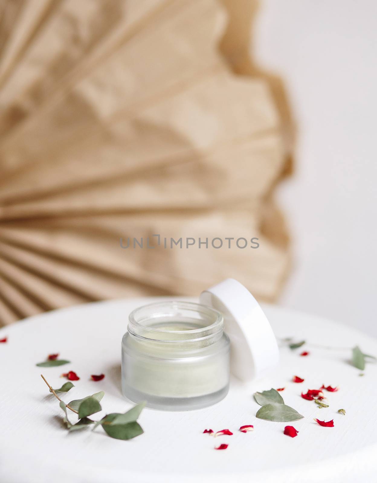 Powder cosmetic mask. Glass jar with matcha on a white background with dry petals. by Denys_N