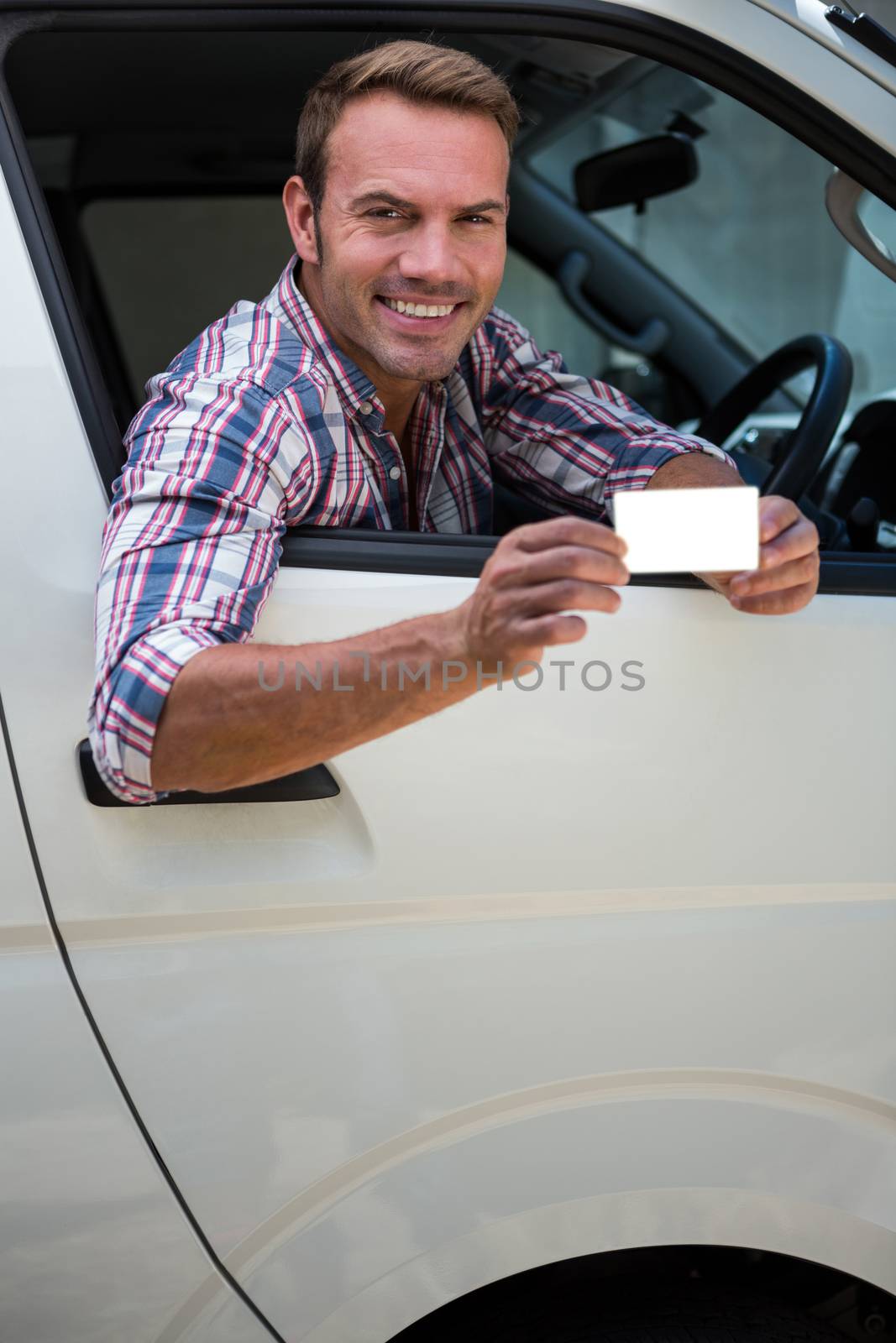 Young man showing his drivers license by Wavebreakmedia
