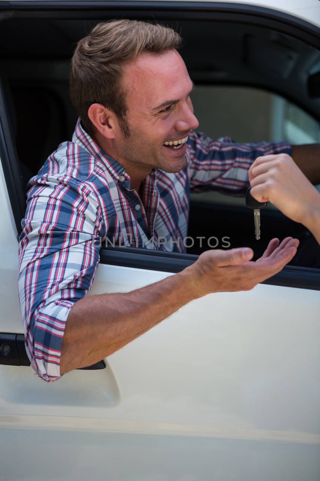 Young man receiving car keys by Wavebreakmedia