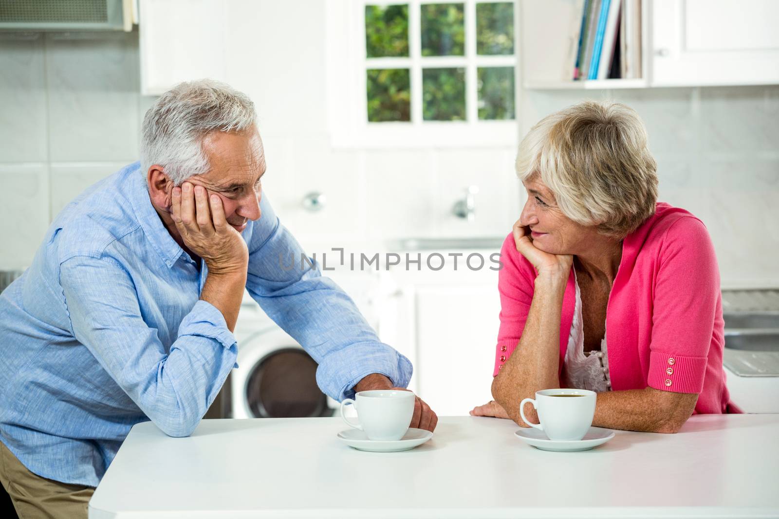 Romantic senior couple with coffee cups by Wavebreakmedia