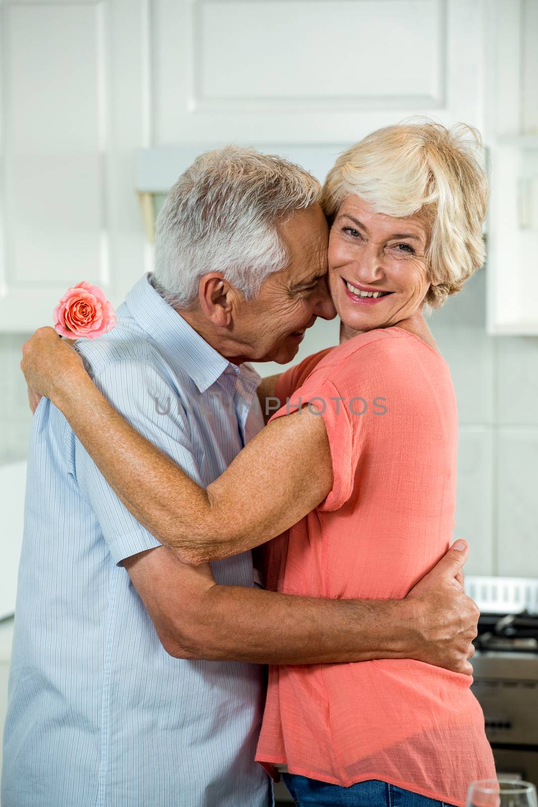 Romantic retired couple with rose  by Wavebreakmedia