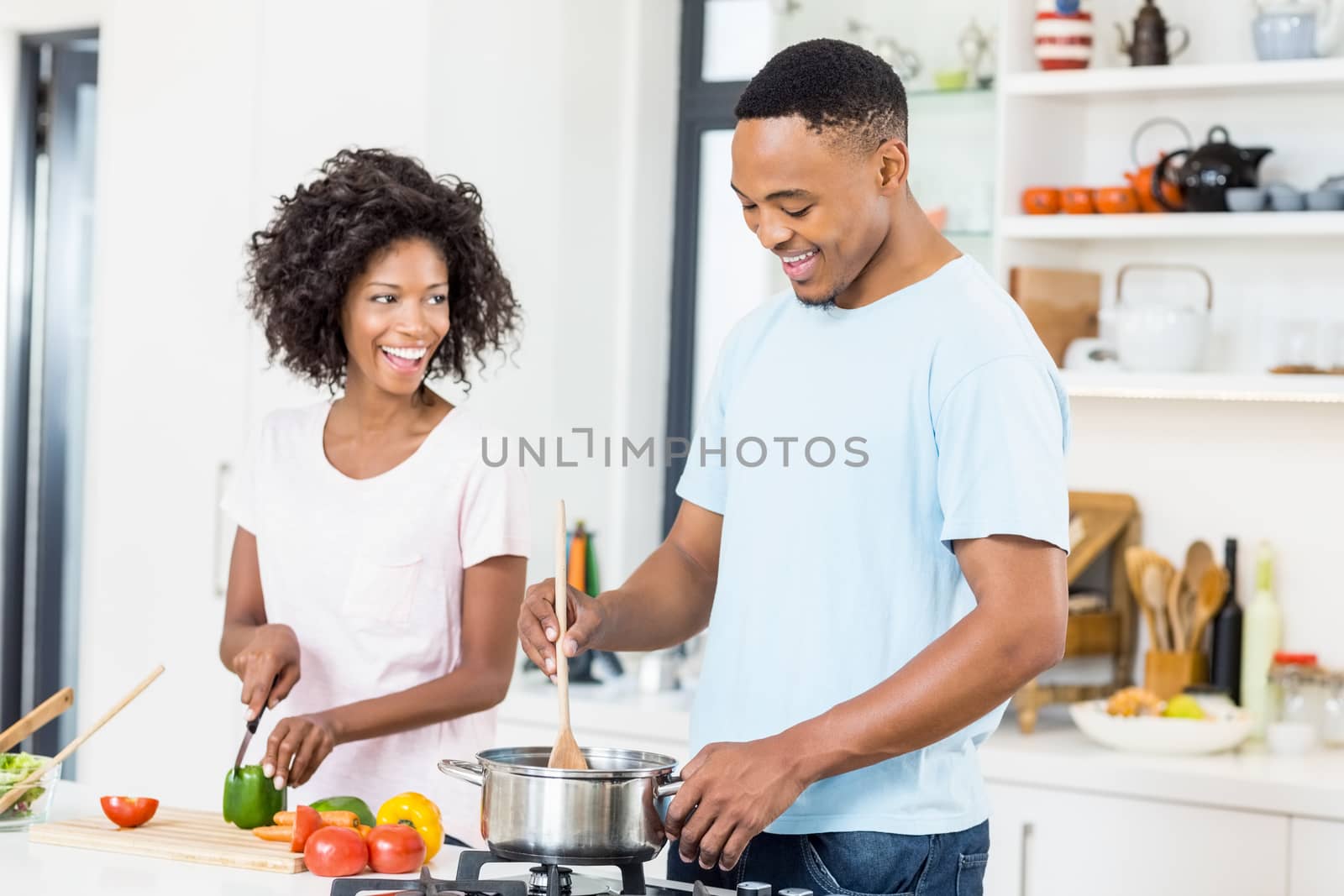 Young couple preparing a meal in kitchen at home