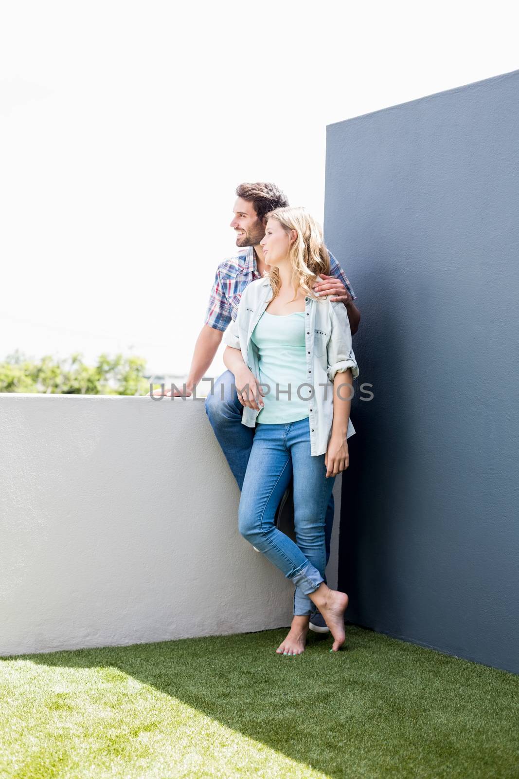 Smiling young couple on terrace