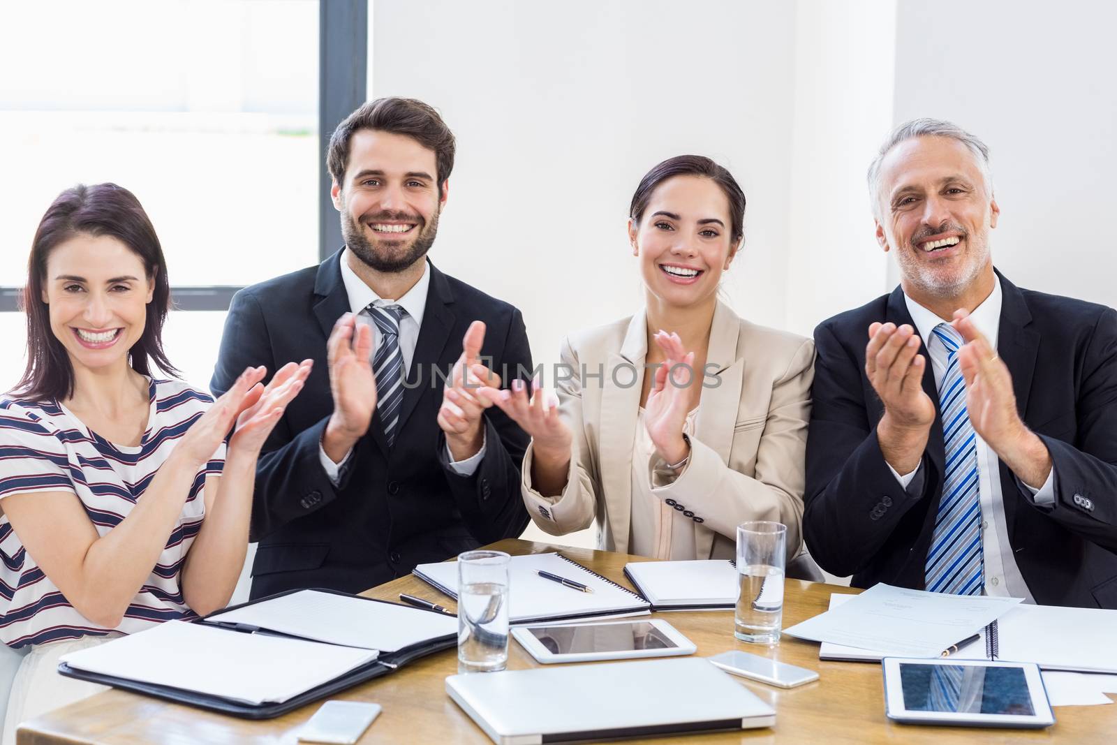 Workers are applauding and smiling  by Wavebreakmedia