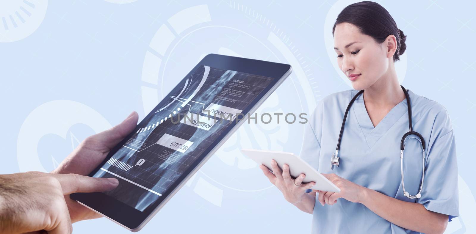Composite image of surgeon using digital tablet with group around table in hospital by Wavebreakmedia