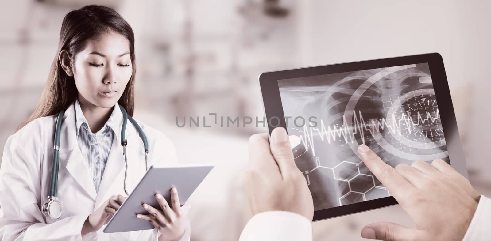 Composite image of asian doctor using tablet by Wavebreakmedia