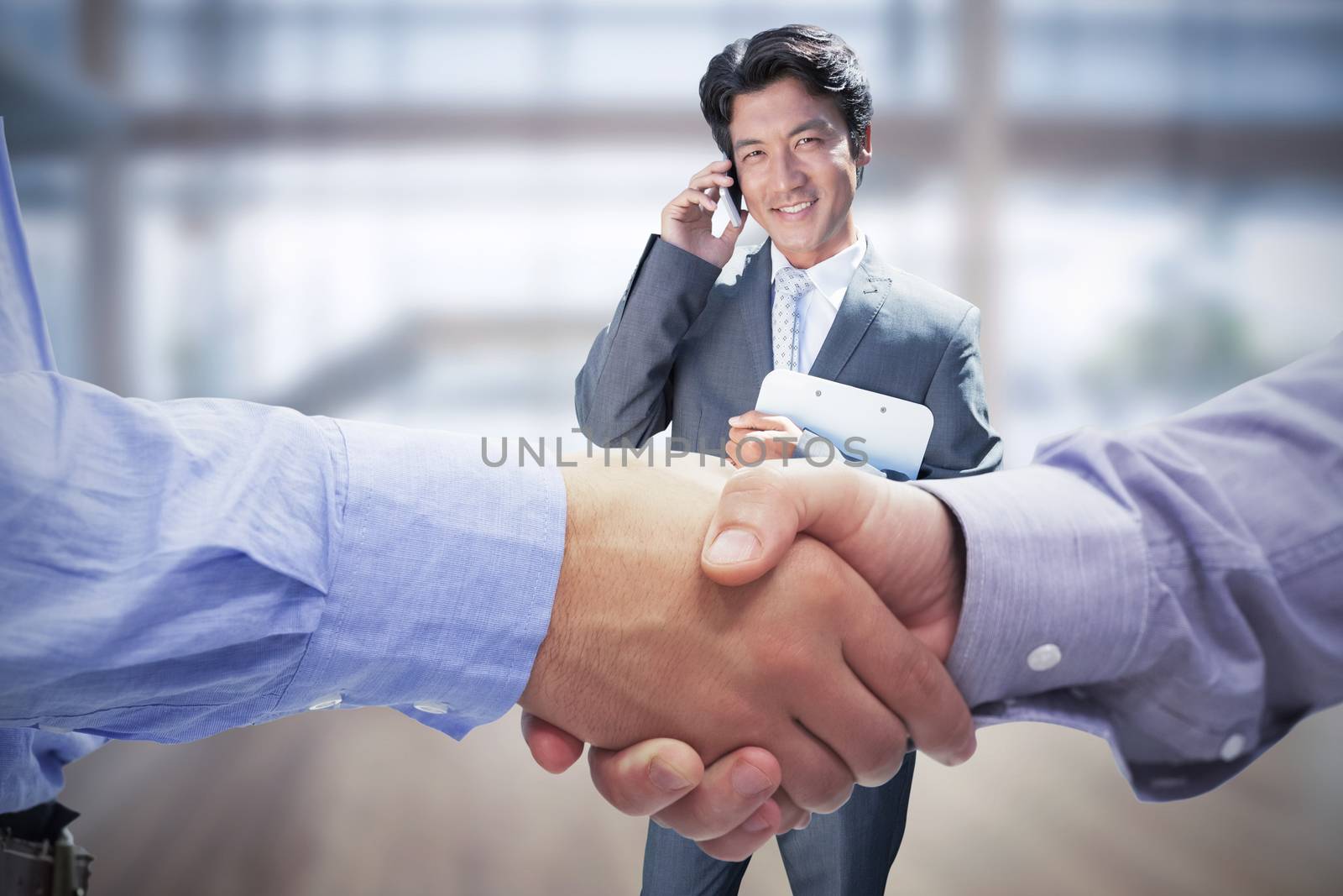 Composite image of two men shaking hands in office