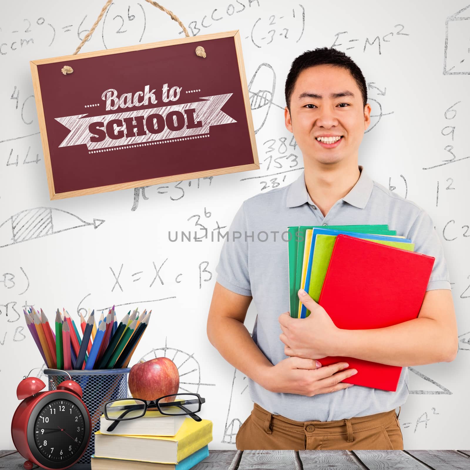 Smiling man holding files against grey background