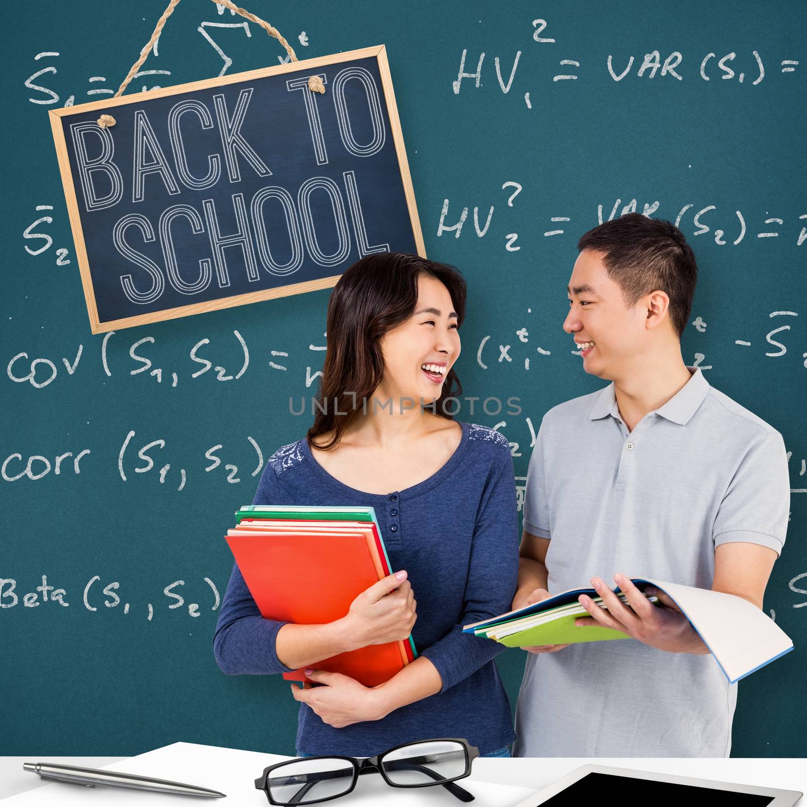 Composite image of couple smiling at each other while holding books by Wavebreakmedia