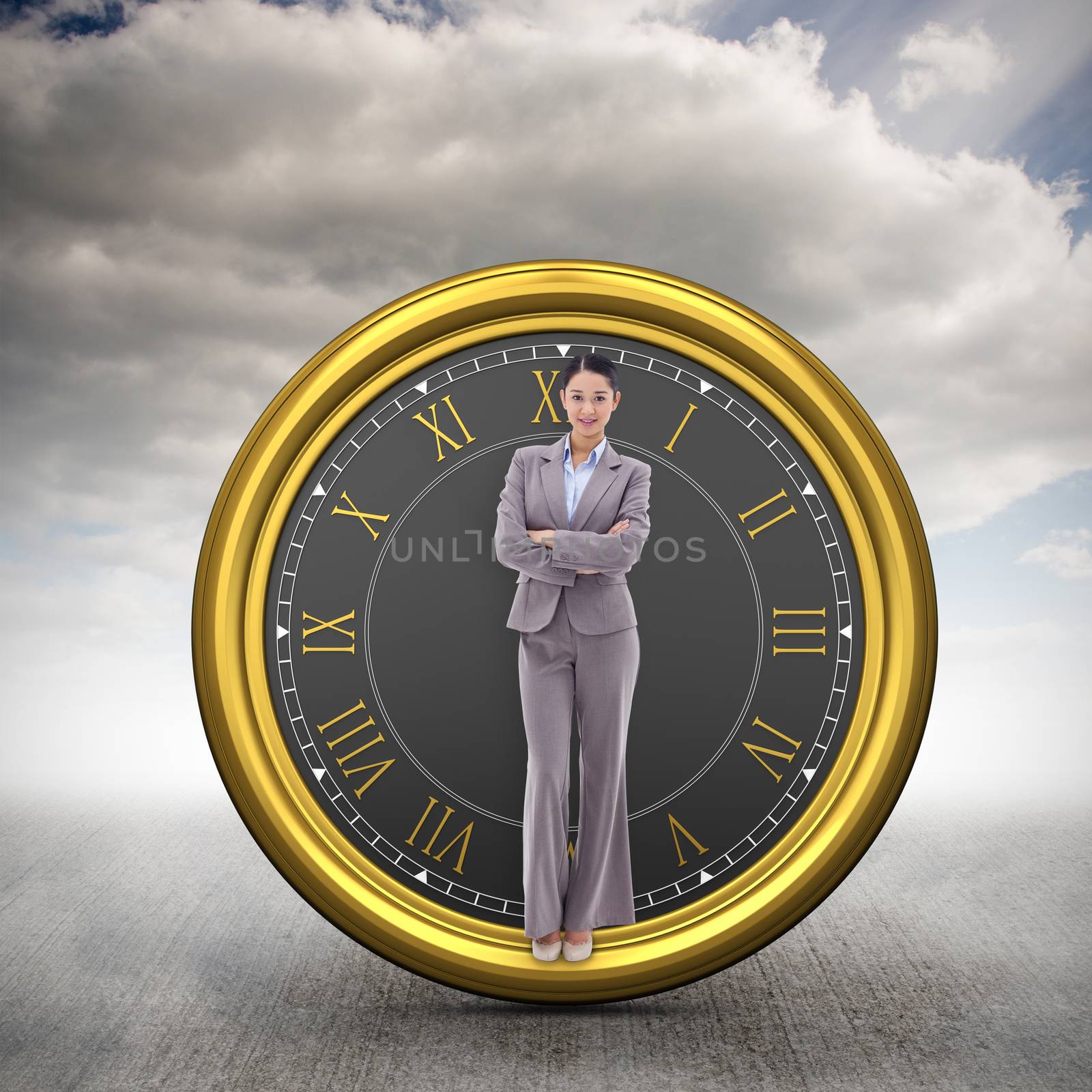 Portrait of a brunette businesswoman with the arms crossed against cloudy sky