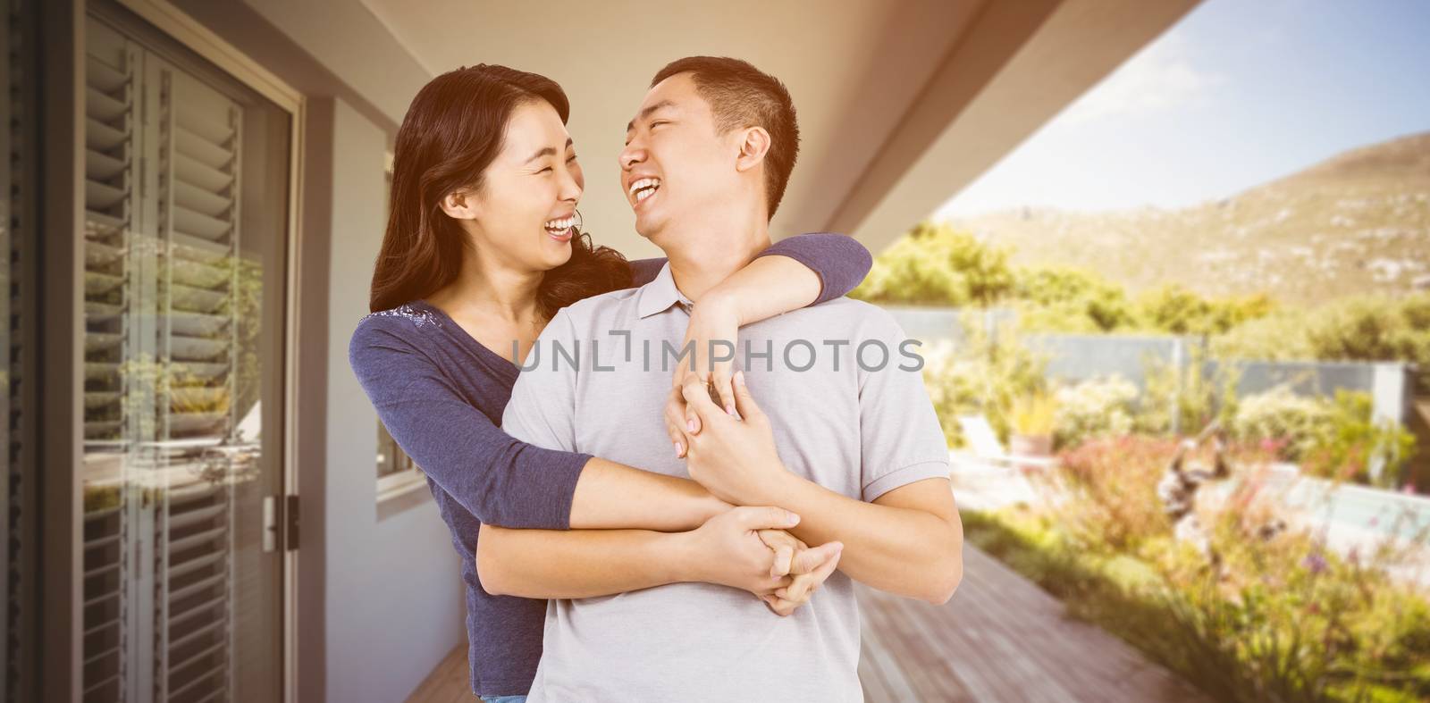 Loving woman embracing man against stylish outdoor patio area