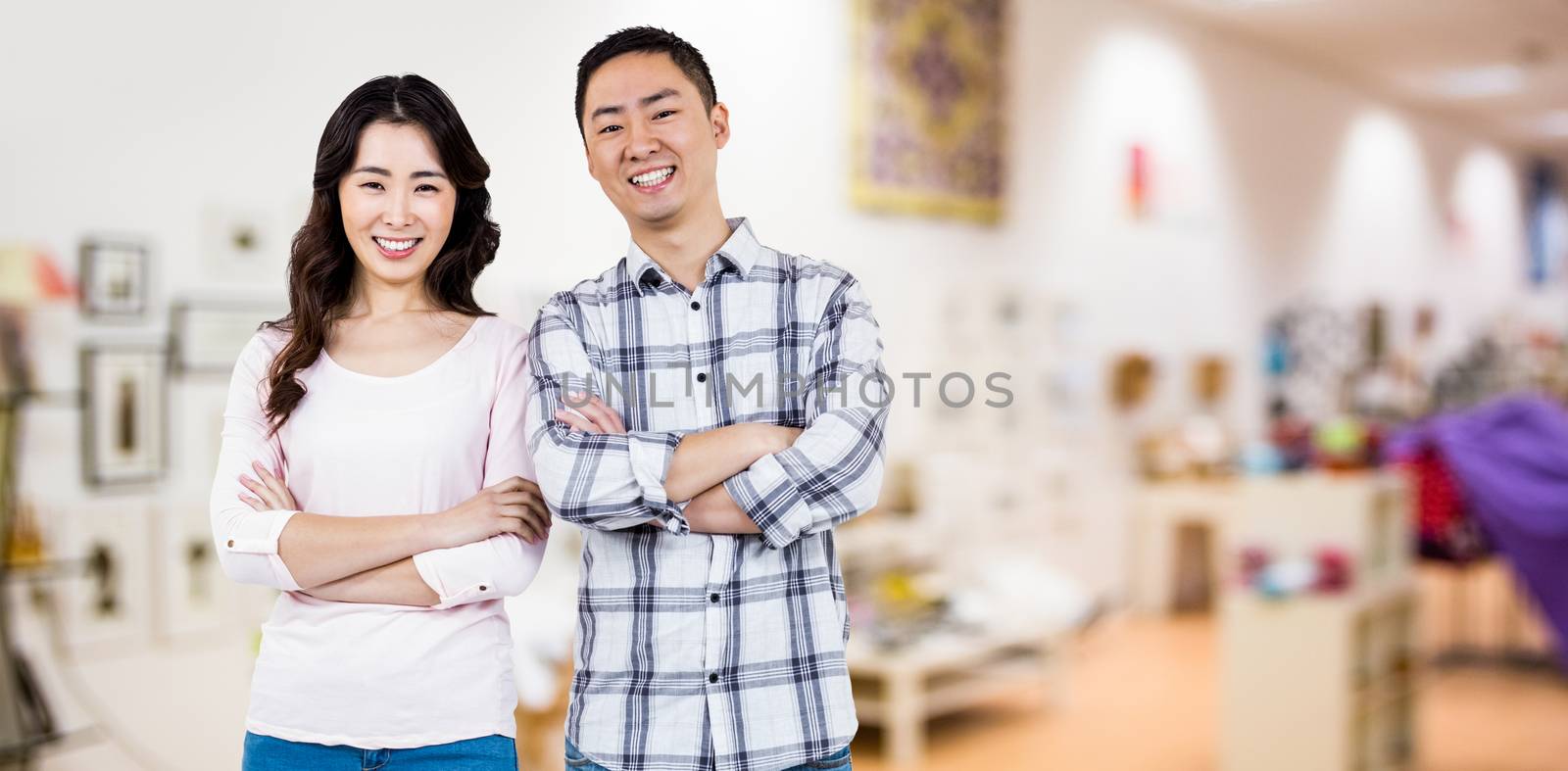 Full length portrait of happy couple  against furniture and design store