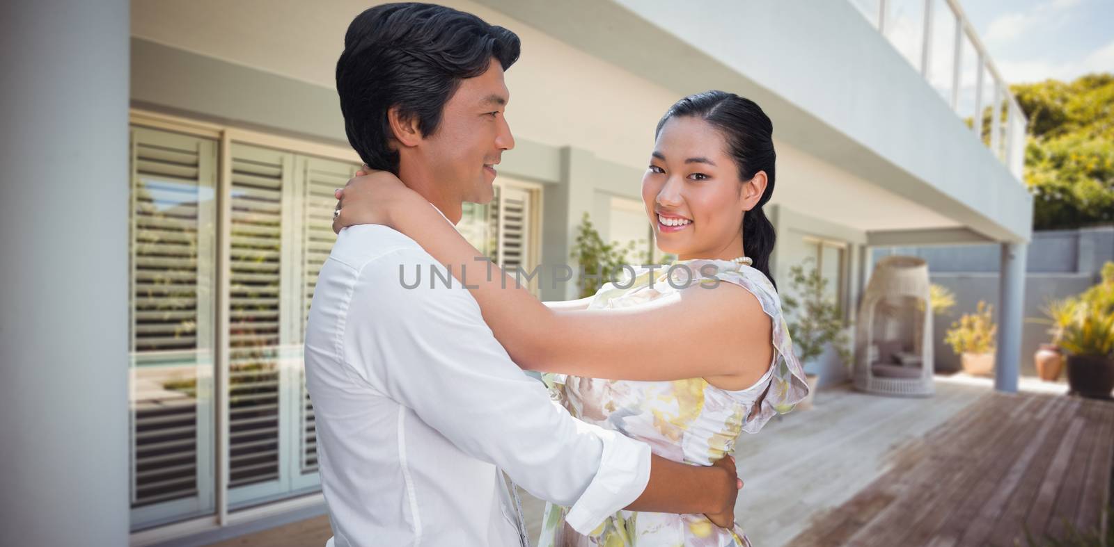 Composite image of happy couple hugging each other by Wavebreakmedia