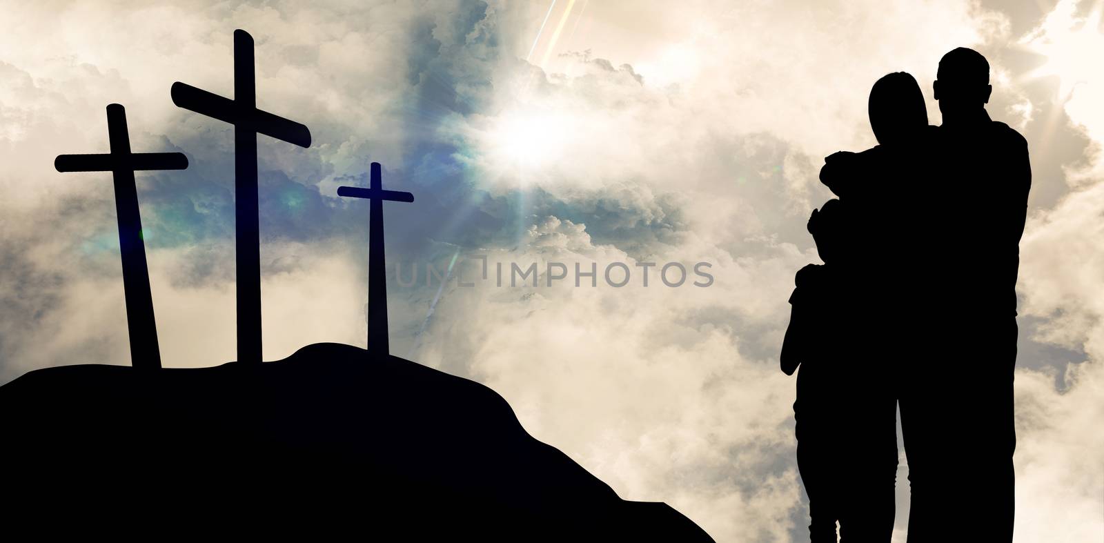 Happy family embracing each other over against cross religion symbol shape over sunset sky 