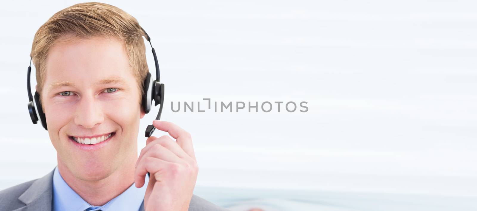 Composite image of handsome agent wearing headset by Wavebreakmedia