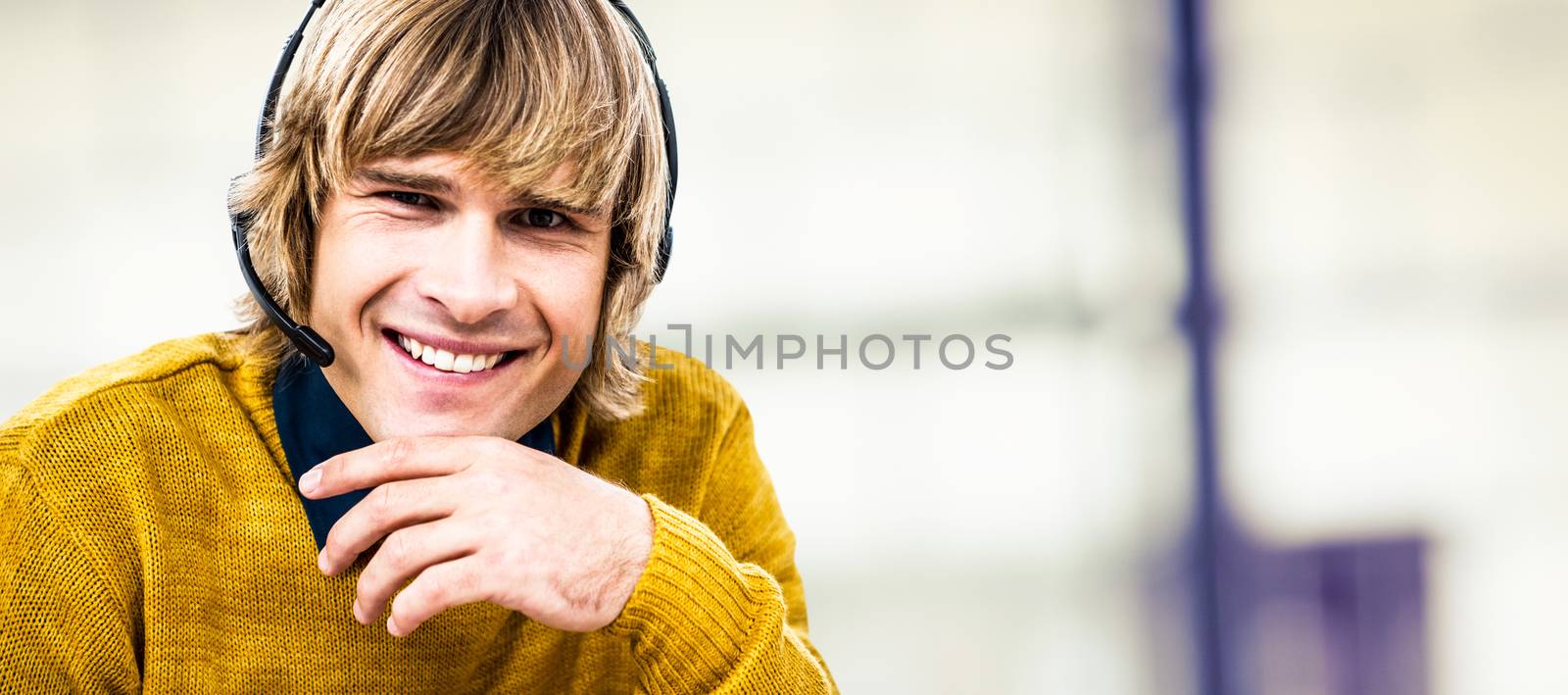 Smiling hipster businessman using headset against pies on a wooden table