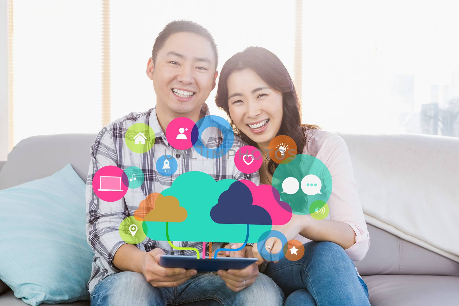 Apps and cloud computing concept against young happy couple holding digital tablet 