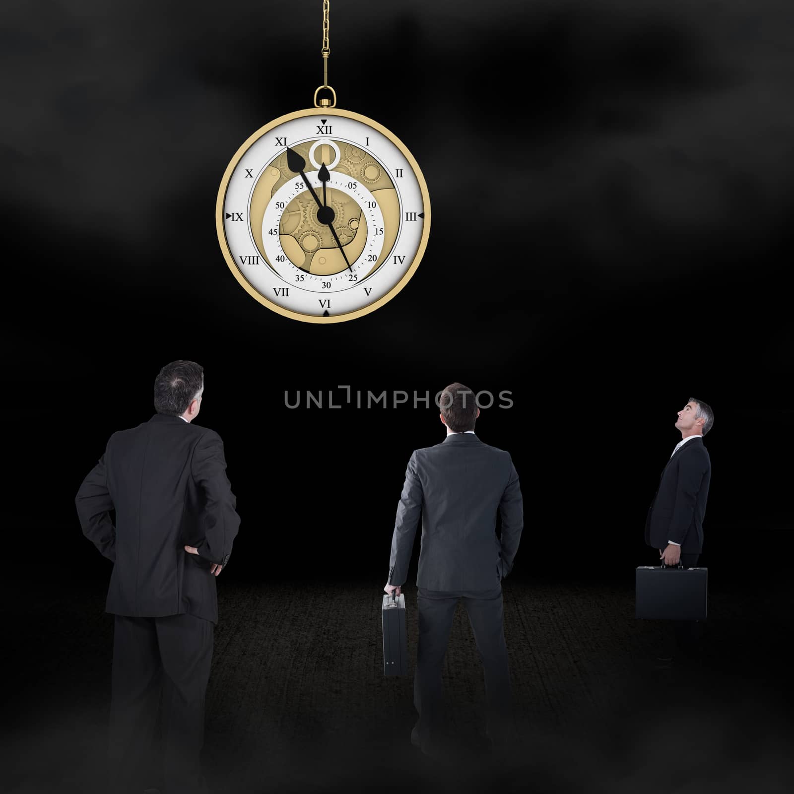 Businessman carrying briefcase against hanging pocketwatch