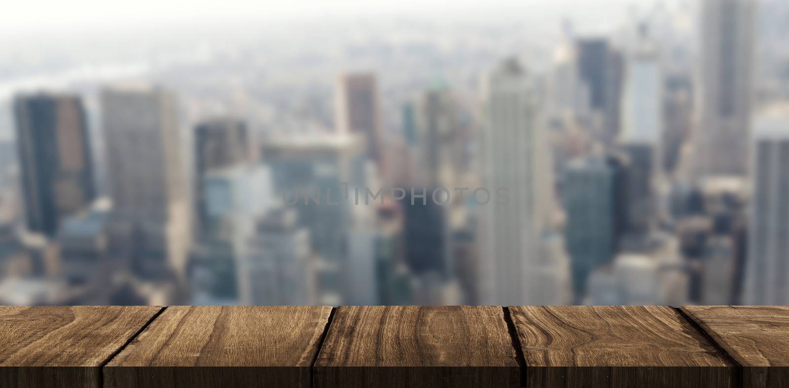 Wooden desk against view of cityscape