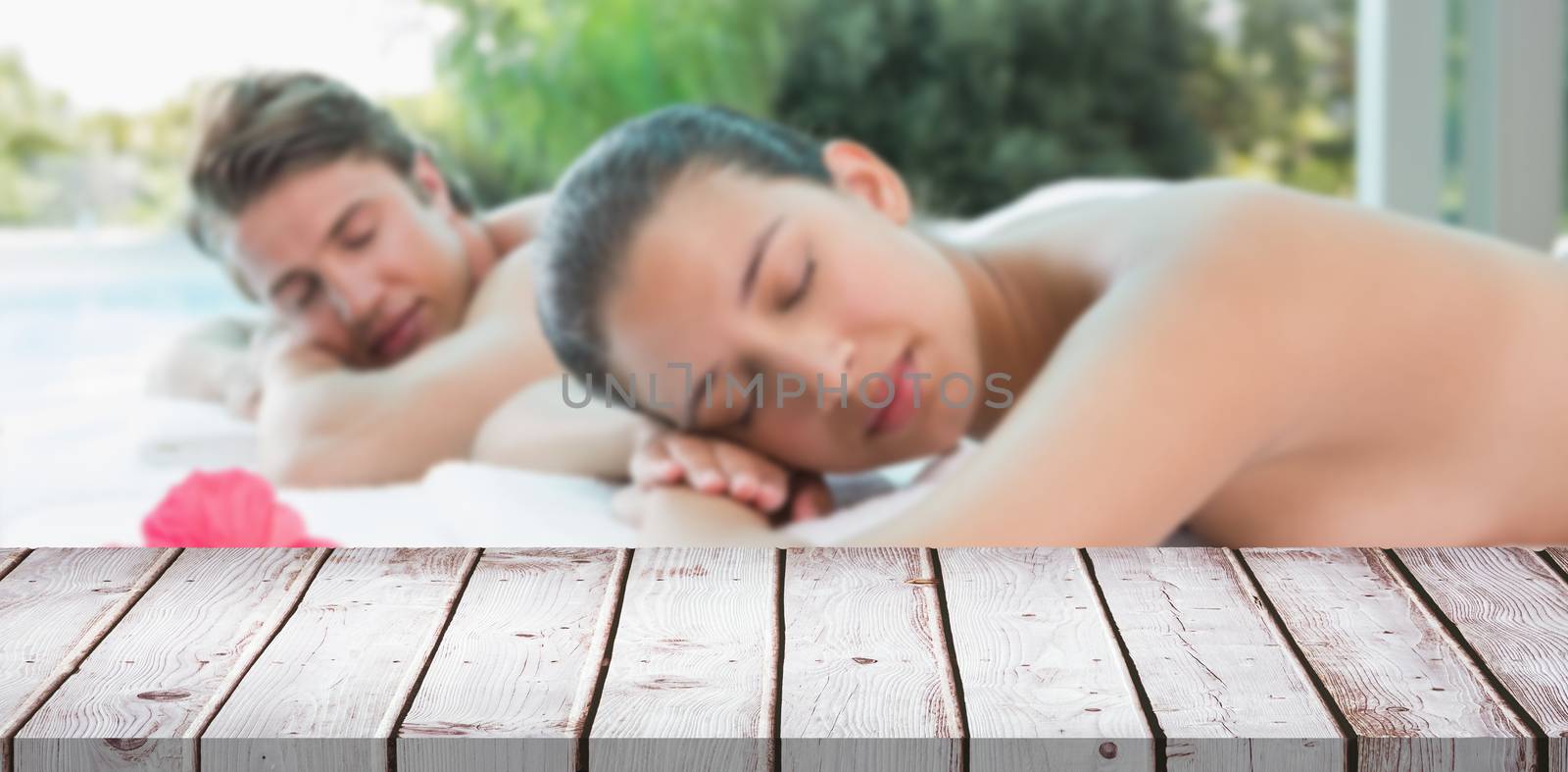 Composite image of couple lying on massage table at spa center by Wavebreakmedia