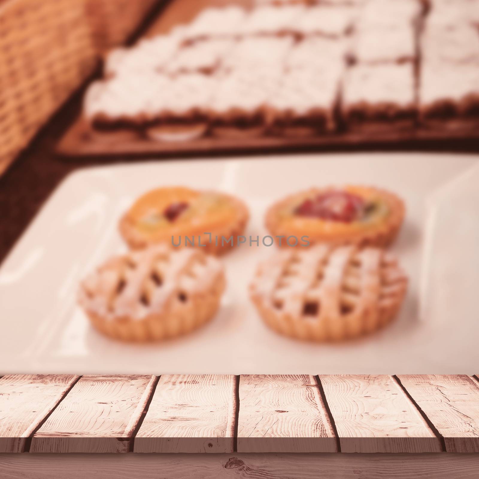 Wooden desk against  close up of basket with fresh bread and pastry  Close up of basket with fresh bread and pastry at the bakery