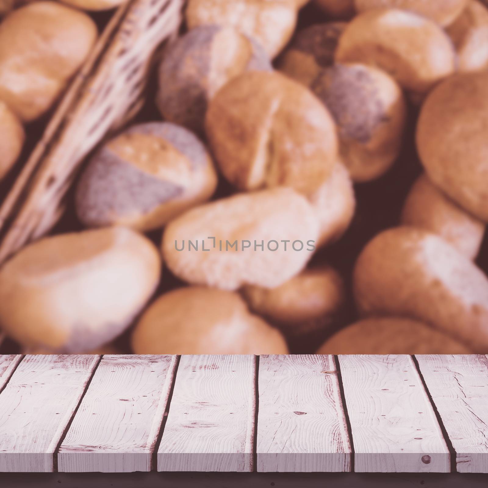 Wooden table against  close up of basket with fresh bread