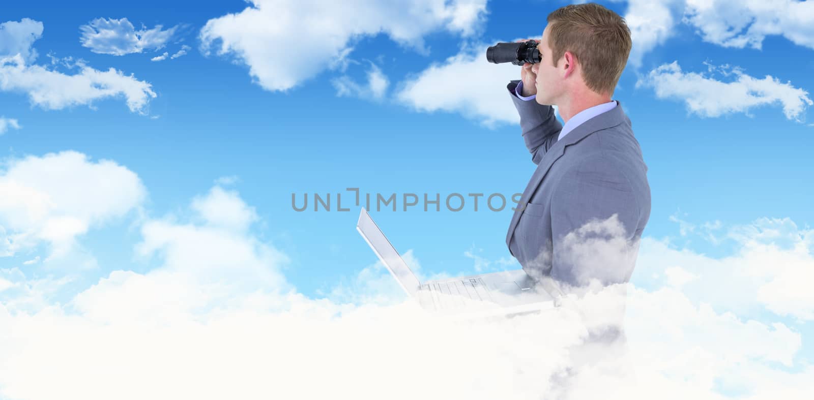 Businessman using binoculars against blue sky