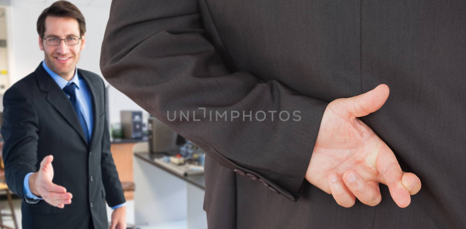 Composite image of businessman with fingers crossed by Wavebreakmedia