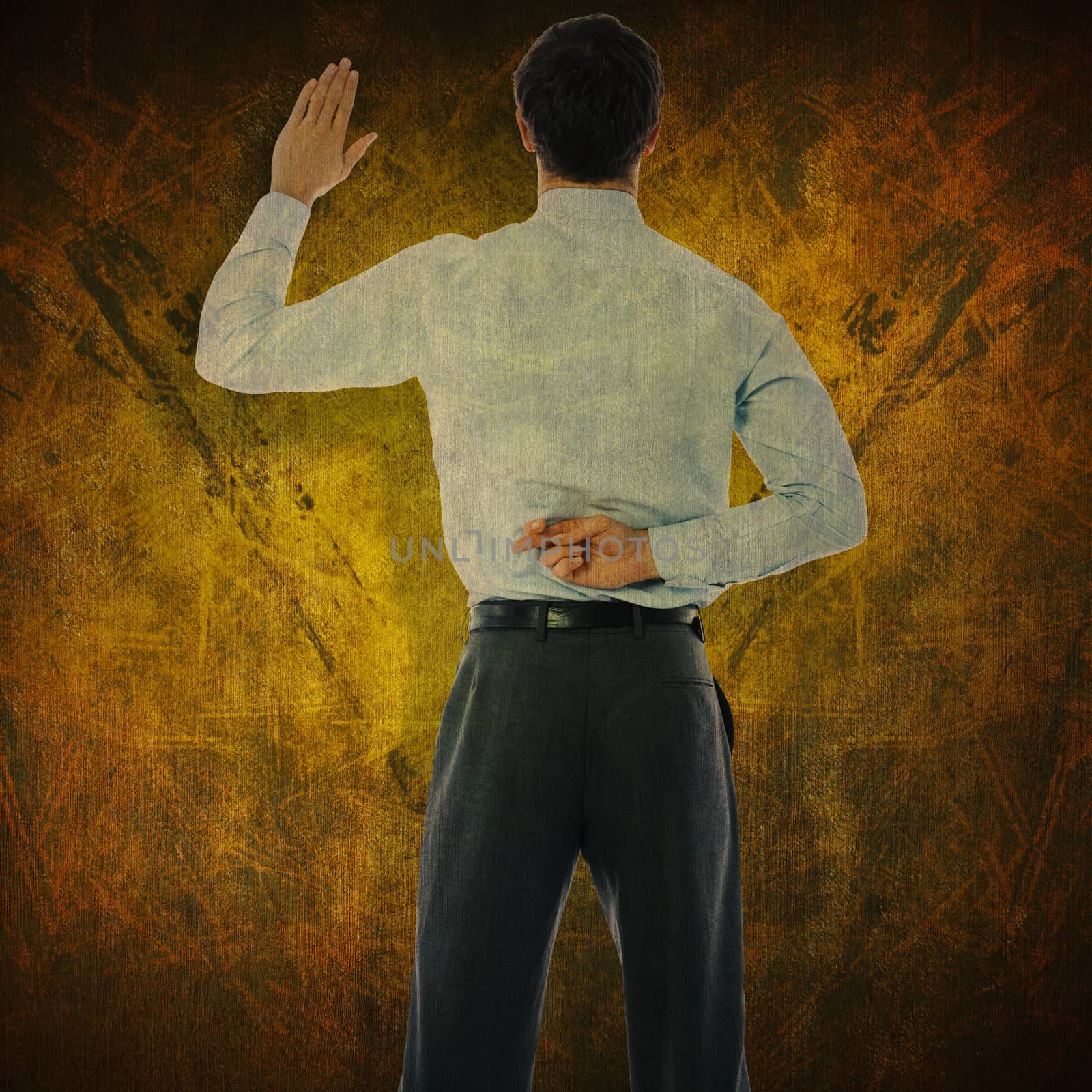 Businessman crossing fingers behind his back against dark background