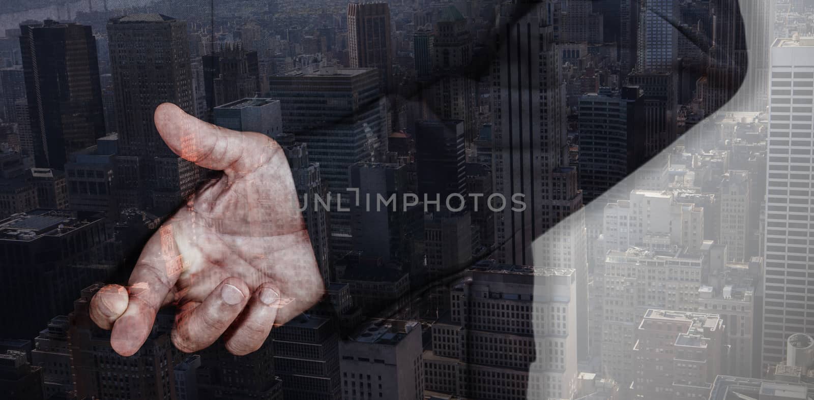 Businessman with fingers crossed against view of cityscape