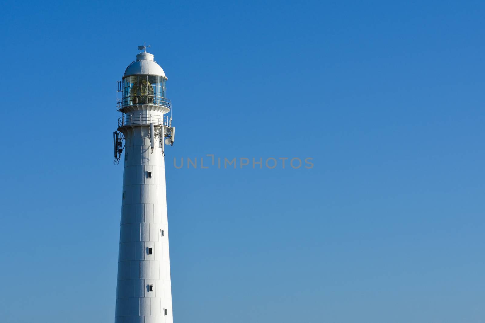 Slangkop lighthouse tower isolated on a clear blue sky, Cape Town, South Africa