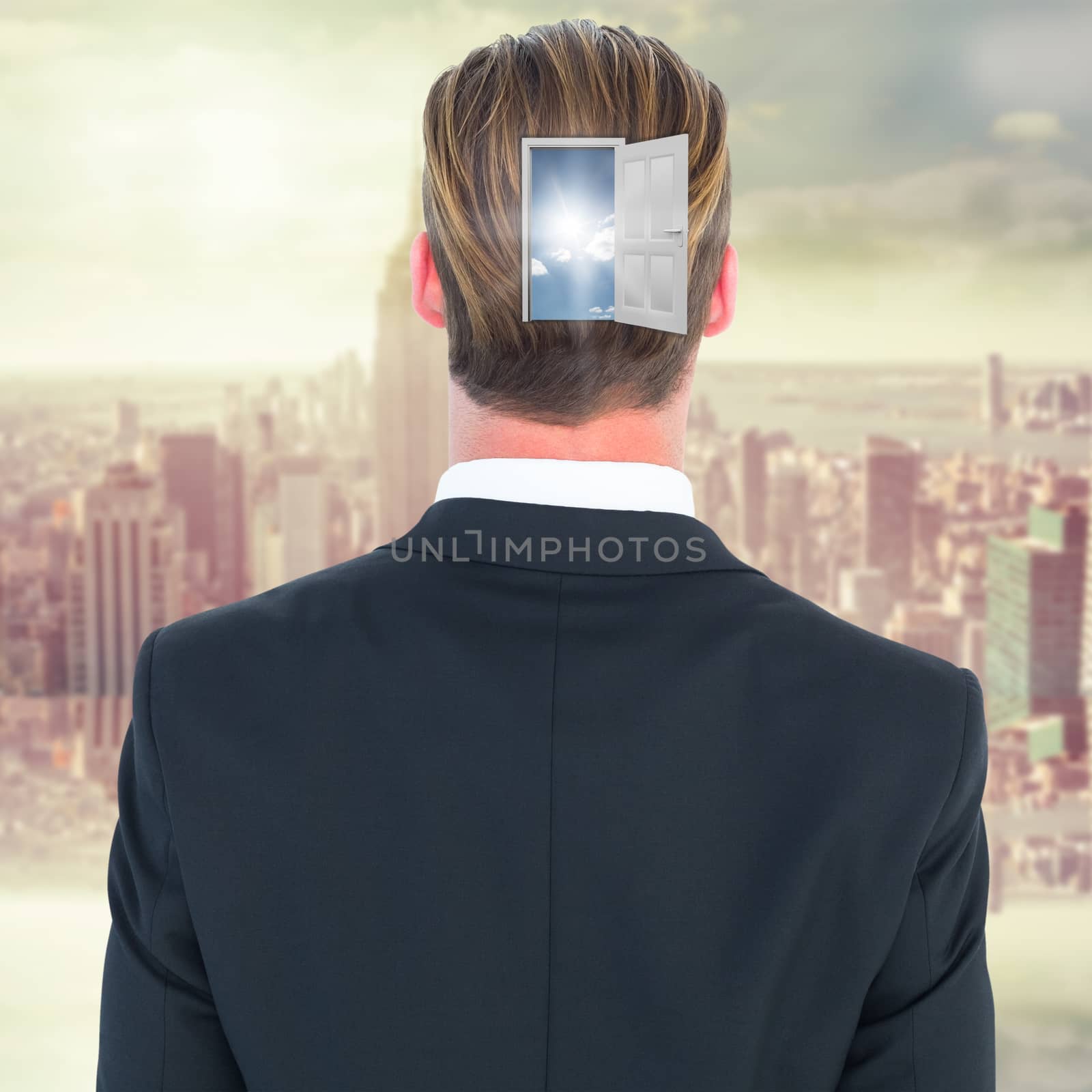 Rear view of elegant businessman in suit posing against room with large window looking on city
