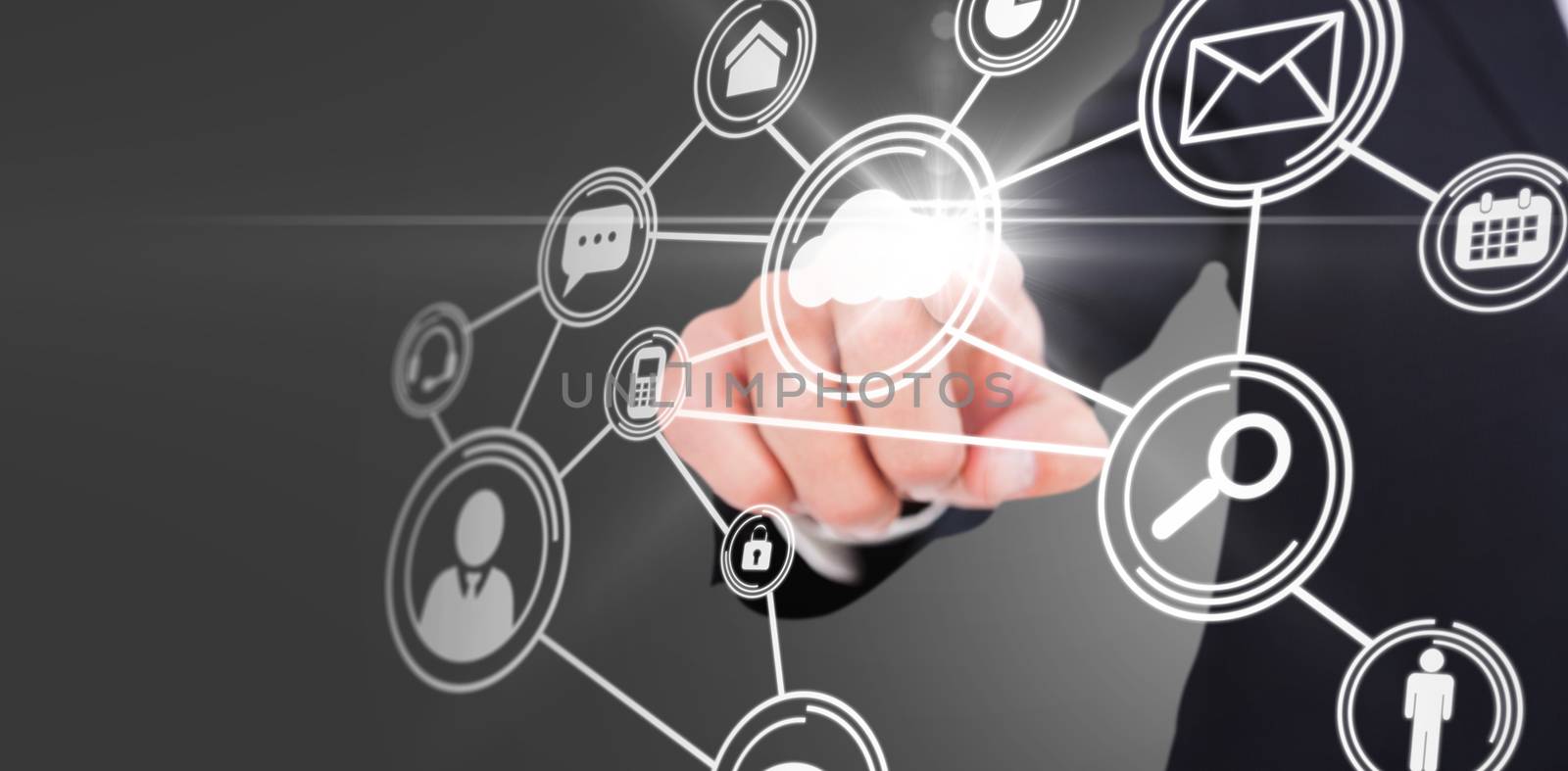 Smiling businessman in suit pointing  against technology interface