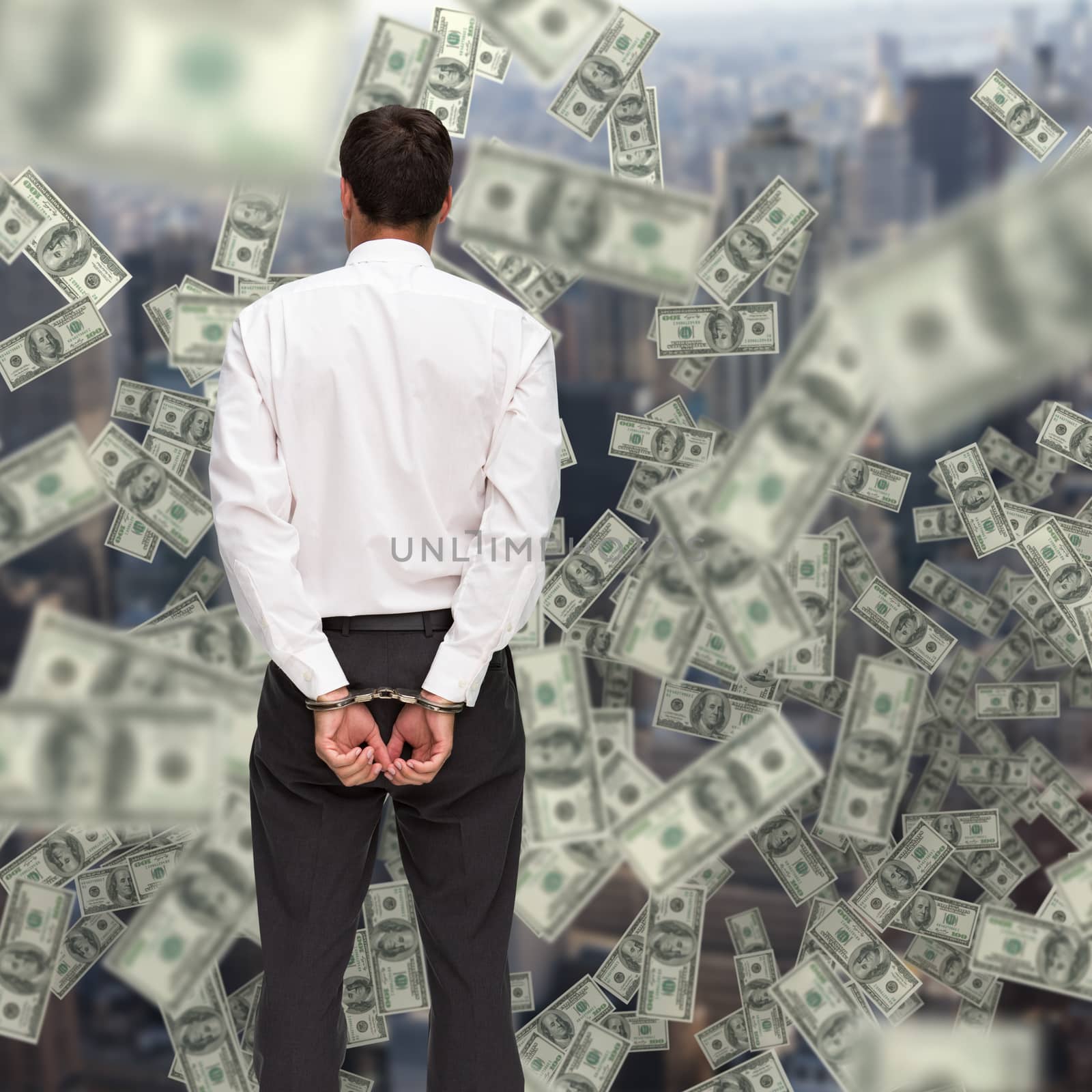 Composite image of rear view of young businessman wearing handcuffs by Wavebreakmedia