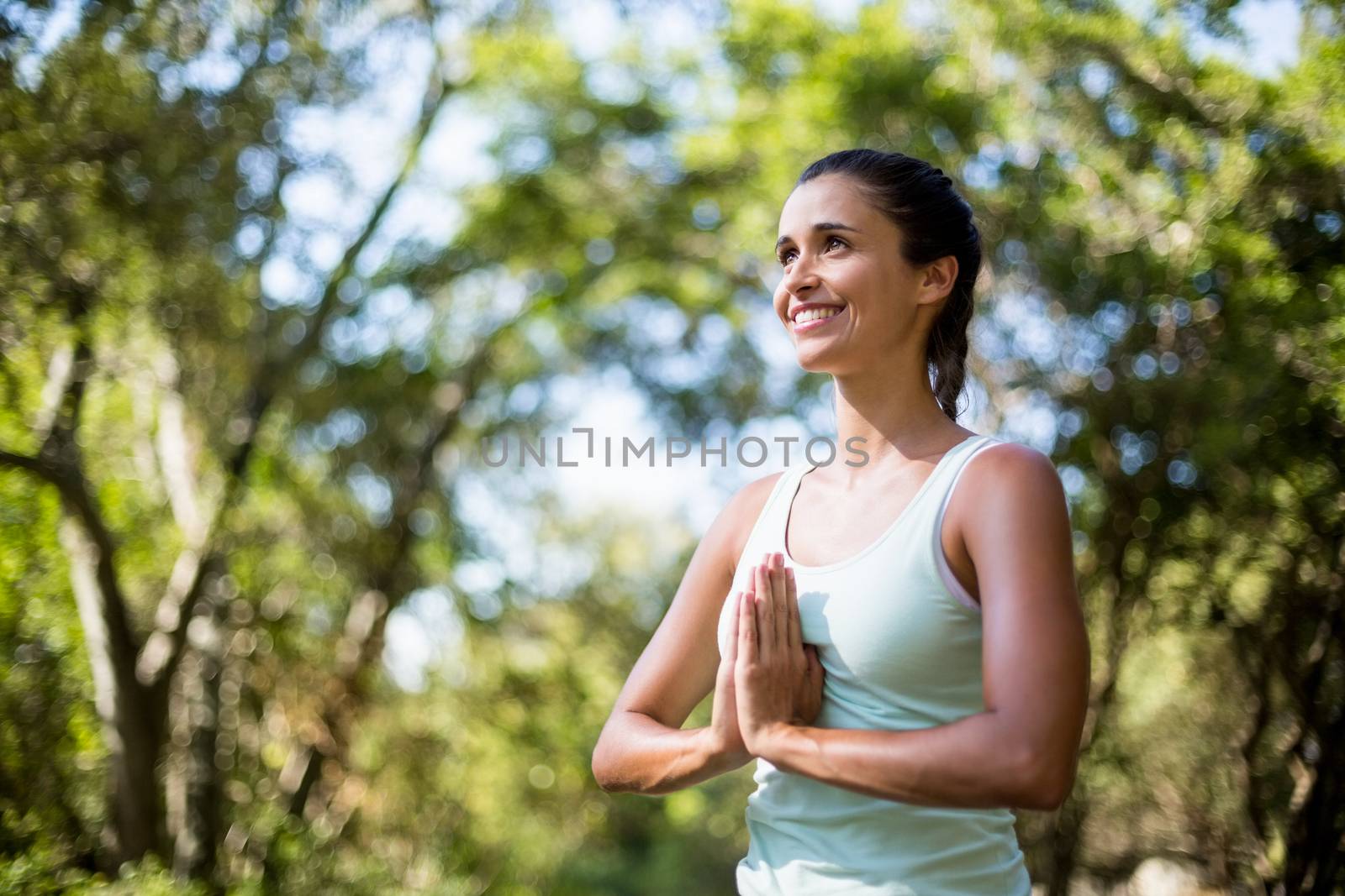 Woman smiling and doing yoga on the wood