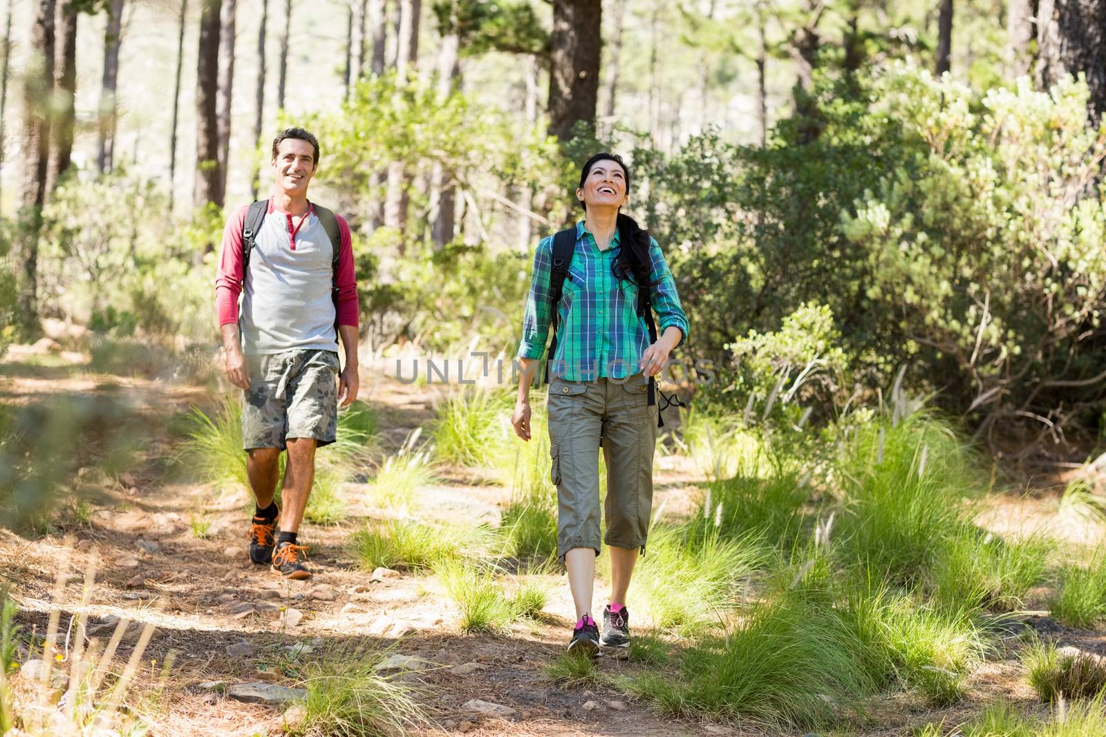 Couple smiling and hiking  by Wavebreakmedia