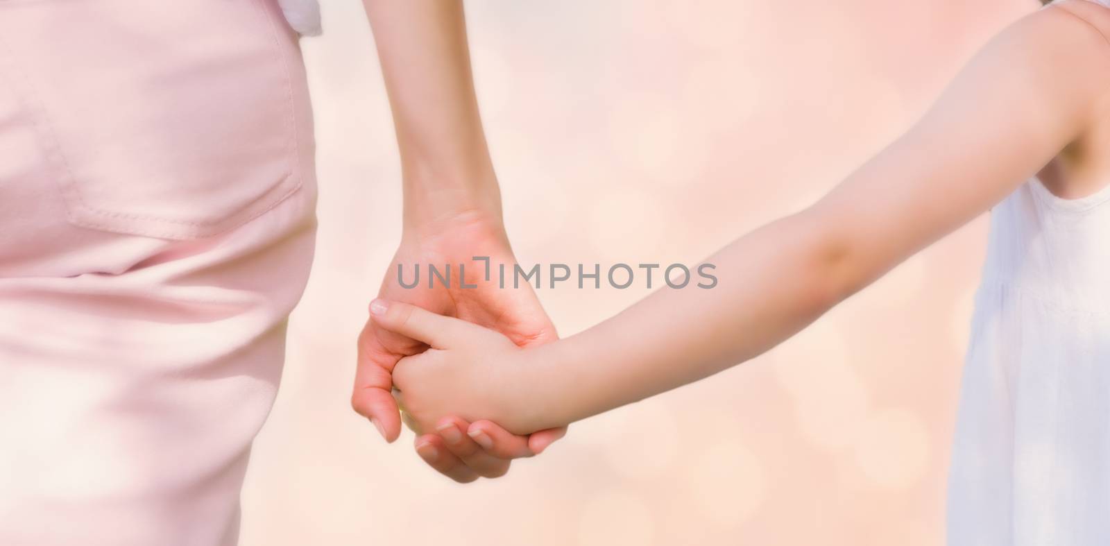Colored background against mother and daughter holding hands