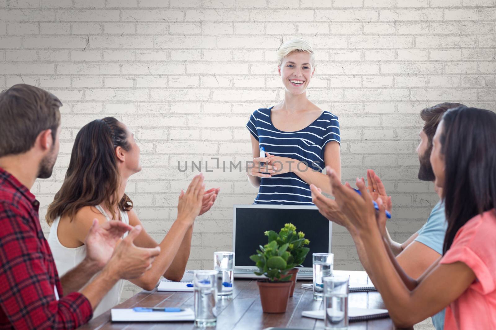 Composite image of colleagues clapping hands in a meeting by Wavebreakmedia
