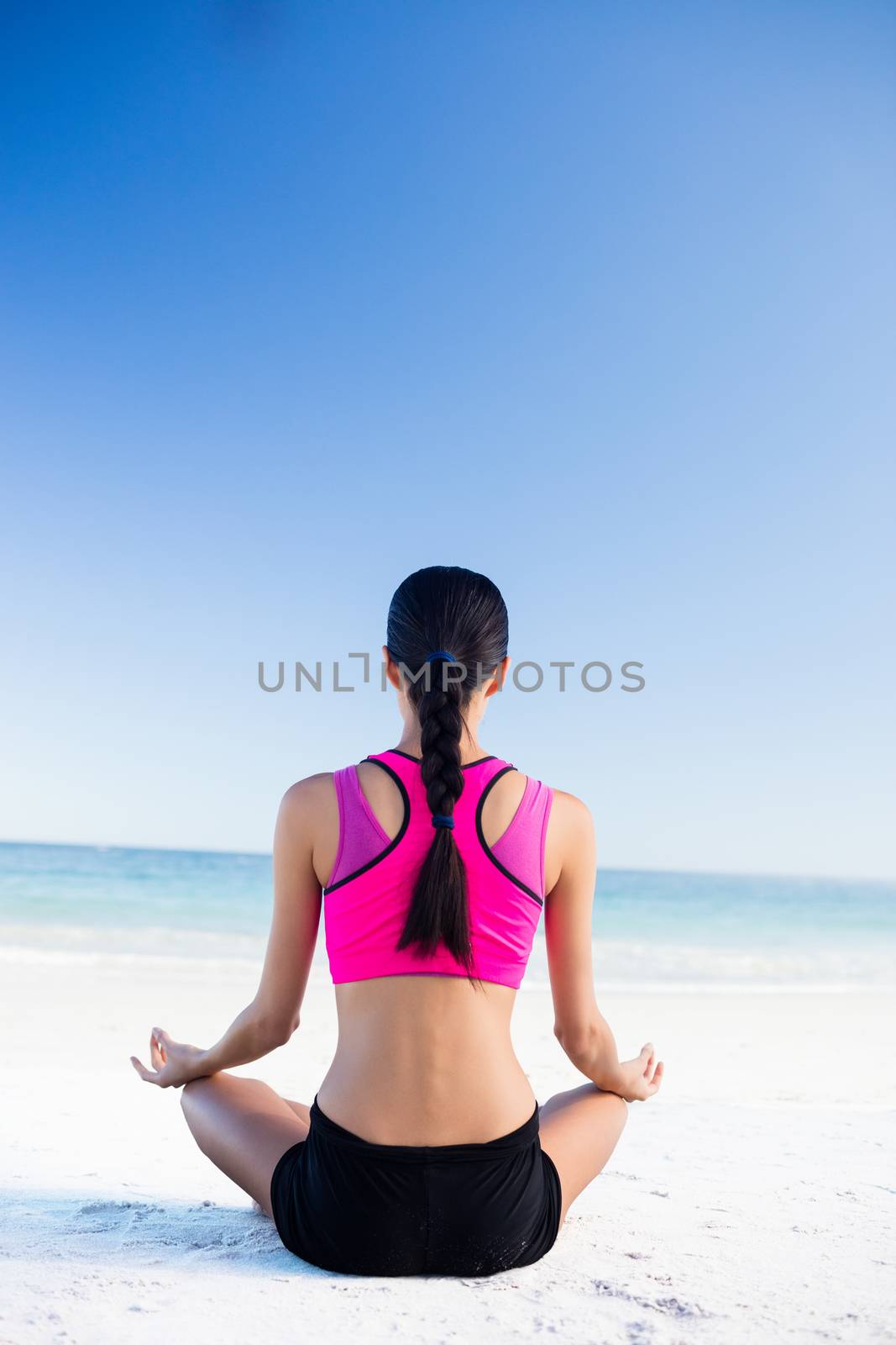 Woman doing yoga on the beach by Wavebreakmedia